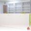 Custom pharmacy shelving system with modular shelves and hygienic finishes, designed for organised medical and retail display