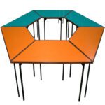 Trapezoidal classroom table with a wide top and sturdy legs, designed at a 510mm height.
