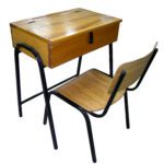 School desk and chair set with black metal frame, wooden seat, wooden backrest, and lift-top wooden desk surface.