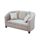 Cream upholstered 2-seater sofa with a curved fluted back, nailhead trim, and turned wooden legs.