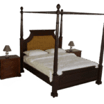 Classic wooden four-poster bed with dark polished wood frame and handwoven cane headboard, styled with white bedding in a warm, elegant bedroom setting.