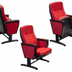 Red fabric auditorium chairs with concealed armrests and black metal frame, designed for comfortable and elegant seating in theatres or conference halls.