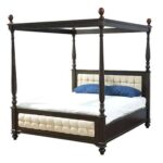 Elegant Amelia poster bed with tall posts, rich walnut-toned wooden frame, and classic silhouette, styled as a luxurious bedroom centrepiece.