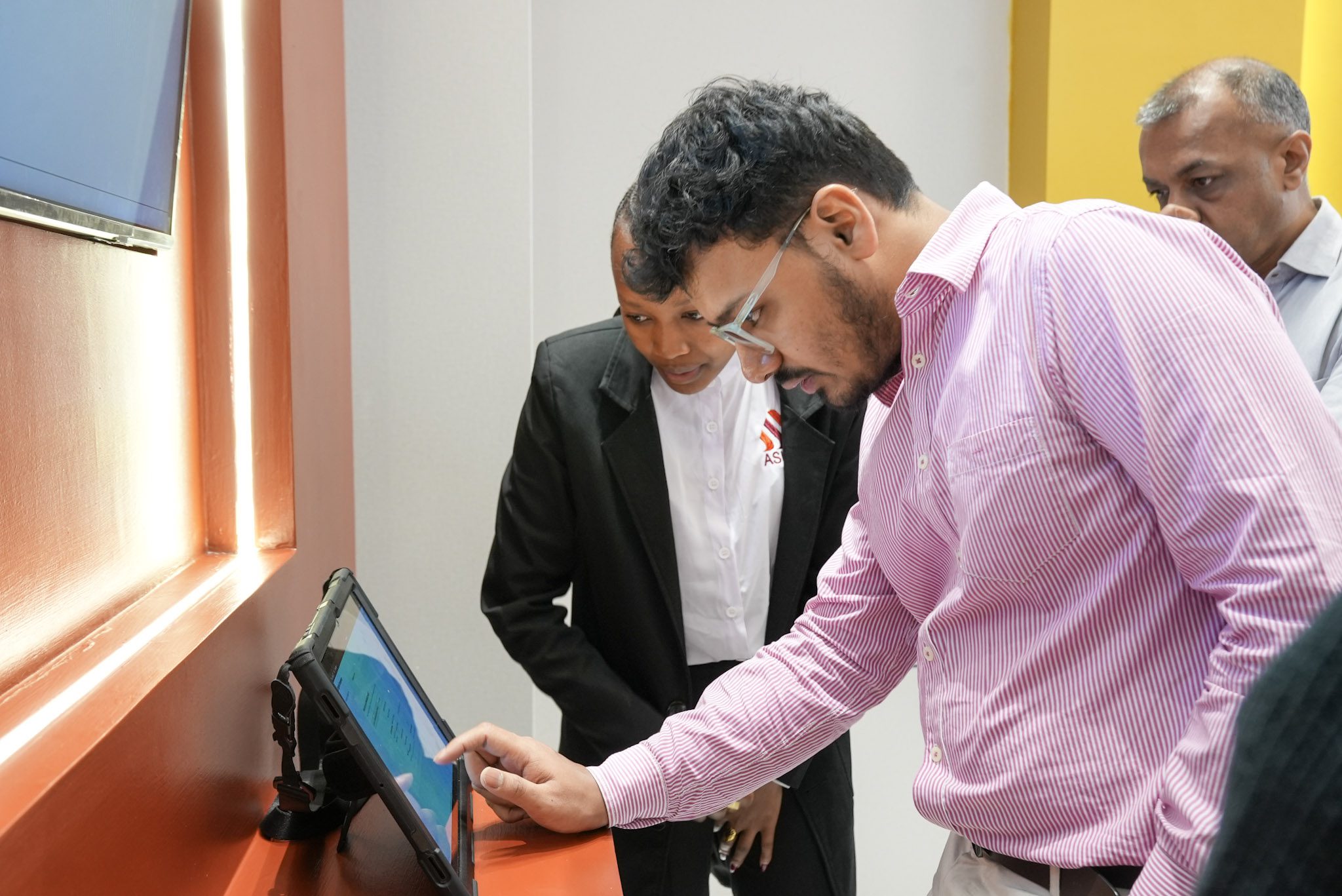 Sales team showing clients the system behind Ashut Experience Centre